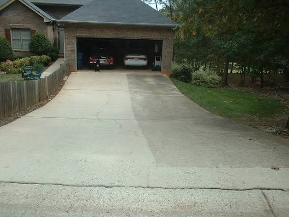 Redline Pressure Washing technician cleaning a driveway